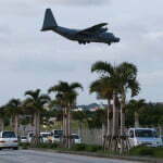 KADENA, JAPAN - FEBRUARY 24: US Air Force C130 aircraft makes a landing approach at the Kadena Air Base on February 24, 2010 in Kadena, Japan. U.S. and Japan will begin talks on Futemma Air Base relocation in early March, following a bilateral agreement originally agreed in 2006 between U.S. and Japan. (Photo by Koichi Kamoshida/Getty Images)