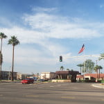 A long-range view of the main gate with the base signs in the foreground.